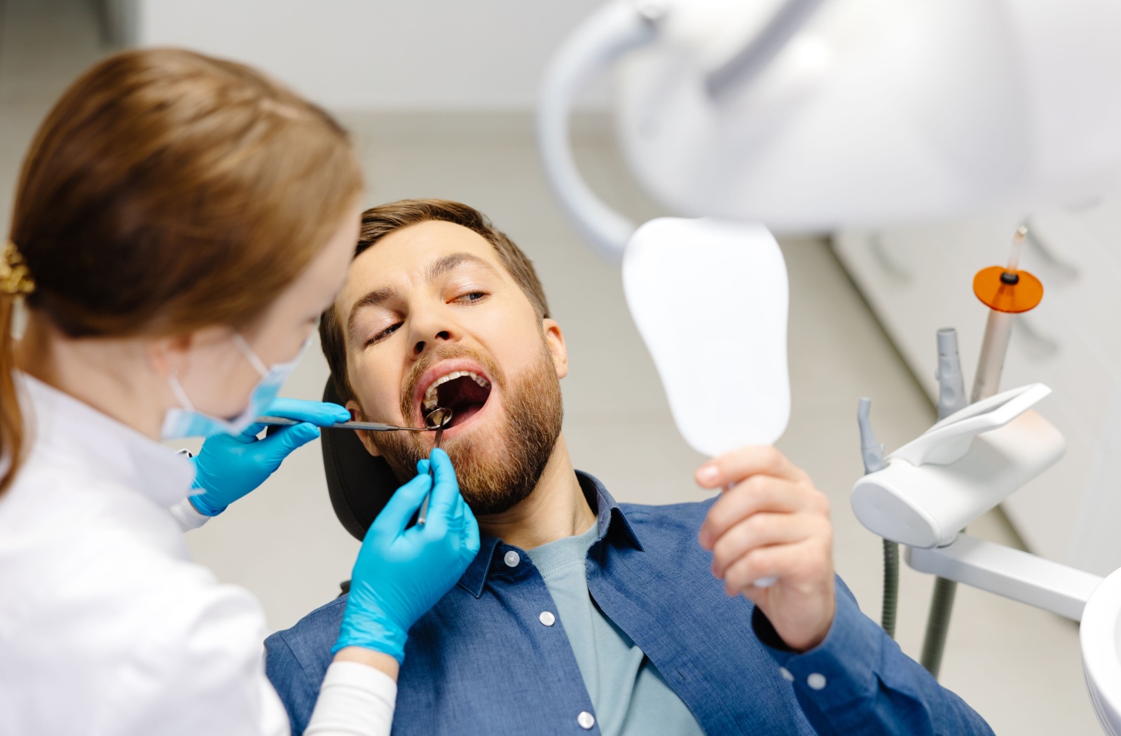A patient at the dentist, having their teeth cleaned to help monitor and maintain good gum health
